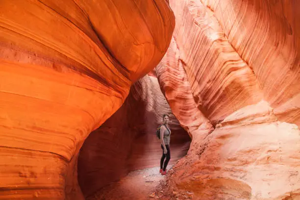 Woman hiking slot canyon