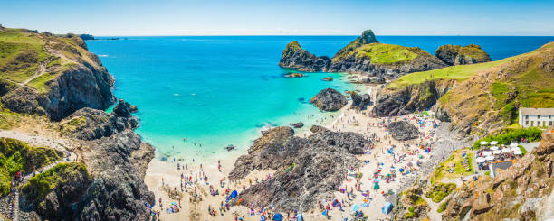 istock Holidaymakers on summer beach beside idyllic ocean bay panorama Cornwall 898375902