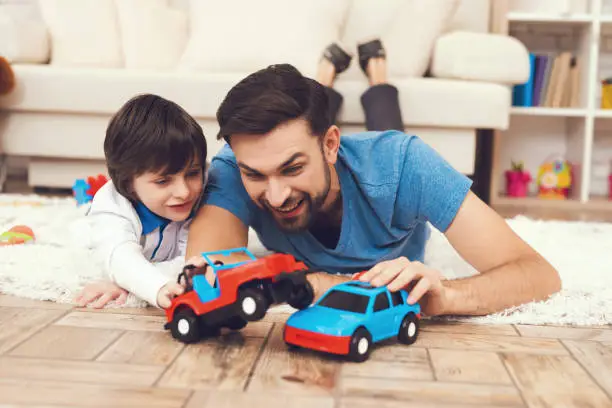 Photo of Father has fun with his son. An exemplary father and a boy at leisure.