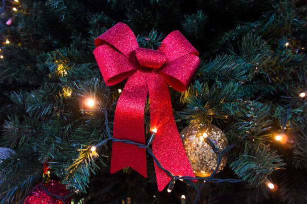 istock Red ribbon , and Golden Ball  on Christmas tree 898379072