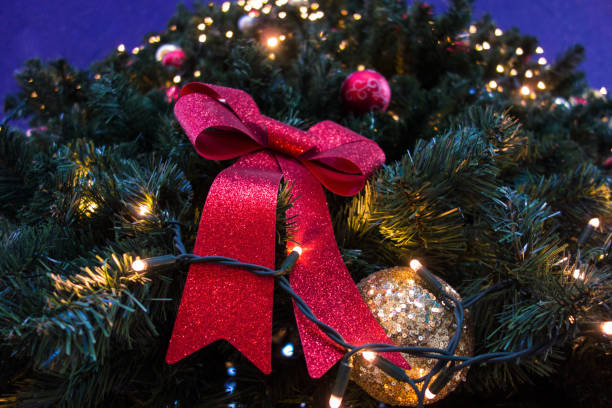 istock Red ribbon ,Golden Ball and Light  on Christmas tree 898379076