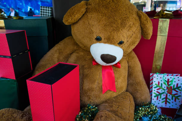 istock A teddy bear and gifts packing under christmas tree 898379132