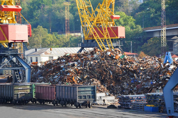 Scrap metal, crane and train in port