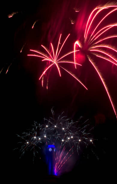 istock Red fireworks like flowers with city hall clock 898381336