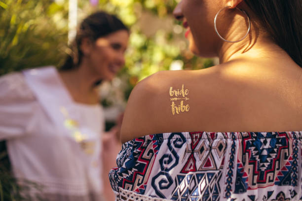 Bride tribe Bride tribe glitter tattoo on a woman's shoulder bachelor and bachelorette parties stock pictures, royalty-free photos & images