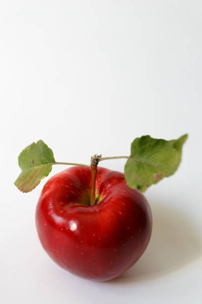 istock Red apple with two leaves on white background 898384722