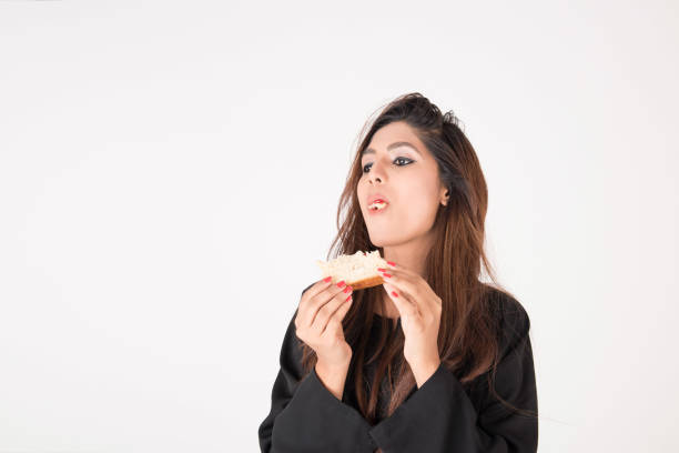 istock Beautiful Arab woman eating sandwich 898386312
