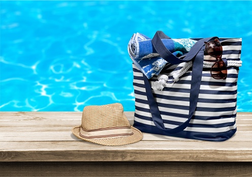Beach bag on pool background
