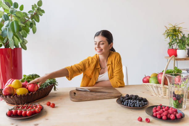 istock smiling woman at table with food 898390422