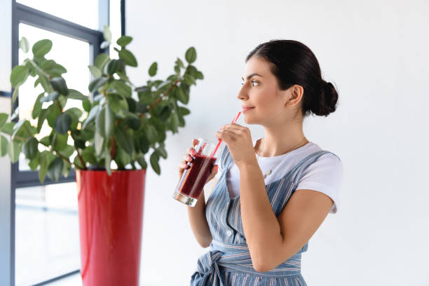 istock thoughtful woman with detox drink 898391464