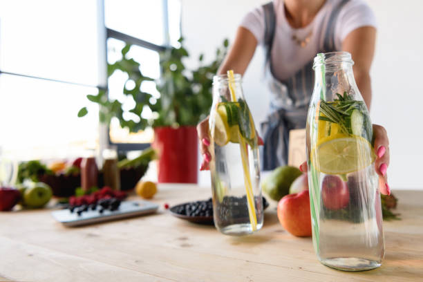 istock woman taking detox drinks from table 898391854