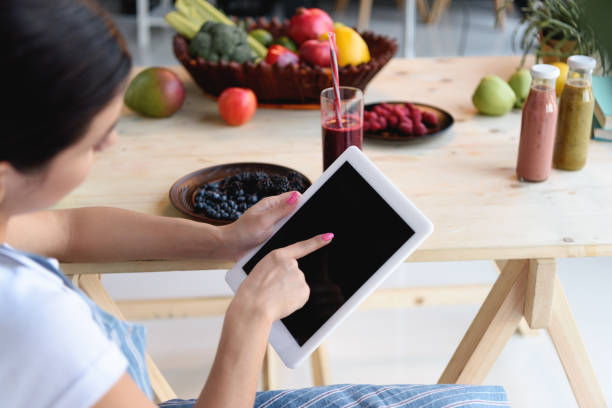 istock woman pointing at tablet 898392190