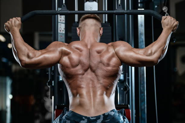 istock Brutal strong bodybuilder athletic men pumping up muscles with dumbbells 898394138