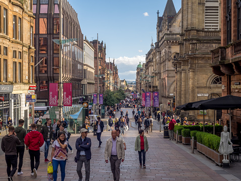Glasgow, Scotland - July 20, 2017: Shoppers explore Buchanan Street in Glasgow on a nice summer day. Buchanan Street is the main pedestrian shopping street in Glasgow.