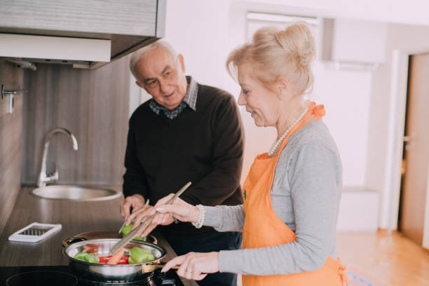 istock Beautiful couple in the kitchen making dinner and chopping the salad 898395092