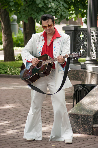 Russia, Moscow June 16, 2012, Hermitage Garden, Food Festival - man with a guitar in the costume of Elvis Presley