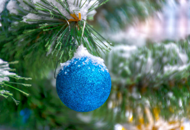 istock Decorated with baubles fir tree outside in the snow. 898396214
