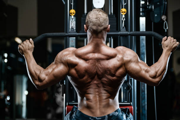 istock Brutal strong bodybuilder athletic men pumping up muscles with dumbbells 898400994
