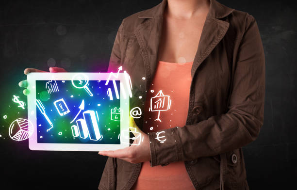 istock Young person holding tablet with graph and chart symbols 898411988