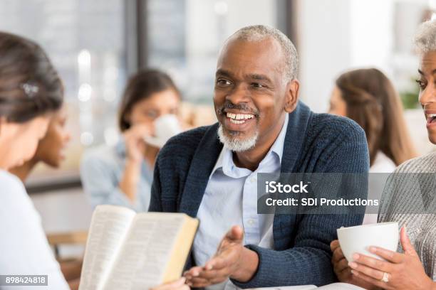 Diverse Group Of People Studying The Bible Stock Photo - Download Image Now - Bible, Studying, Christianity