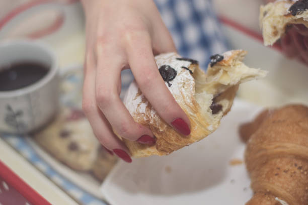 istock Woman having breakfast in bed 898425806