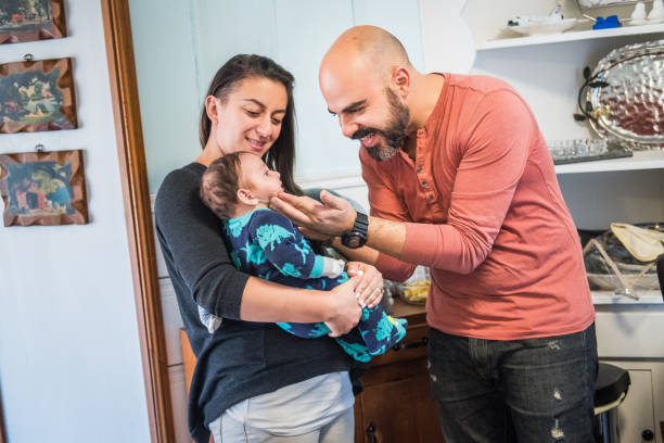 istock Mother and Father play affectionately with toddler 898426114