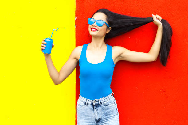 istock Asian woman posing in front of colored wall 898430044