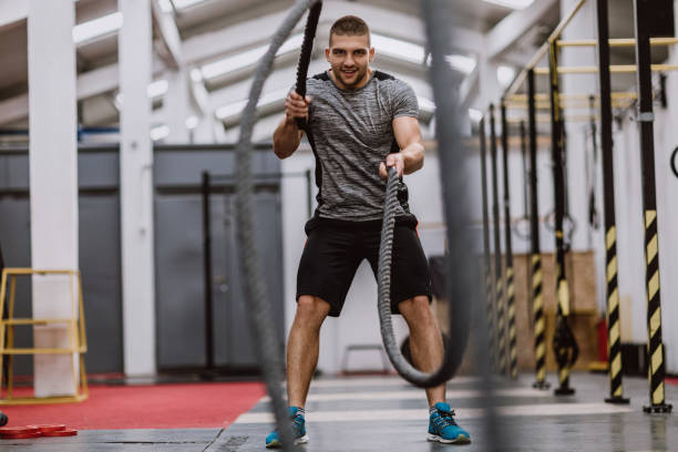 istock Happy Athlete Man Doing Battle Ropes 898430298