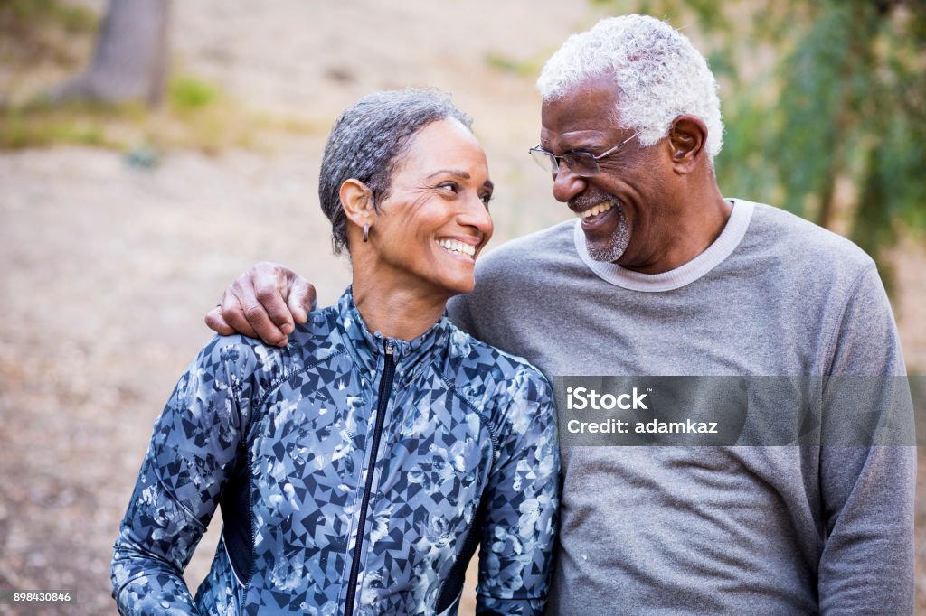 Beautiful Senior Black Couple A beautiful senior African American Couple Smiling Together during their workout Exercising Stock Photo