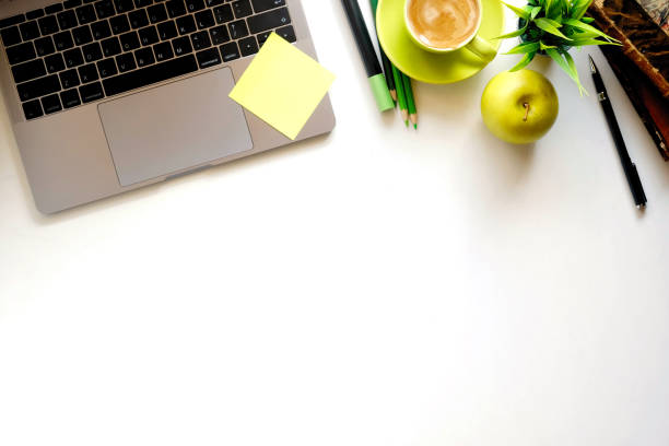istock Mock up Office desk white table with laptop computer, supplies, pen and coffee cup. 898435144