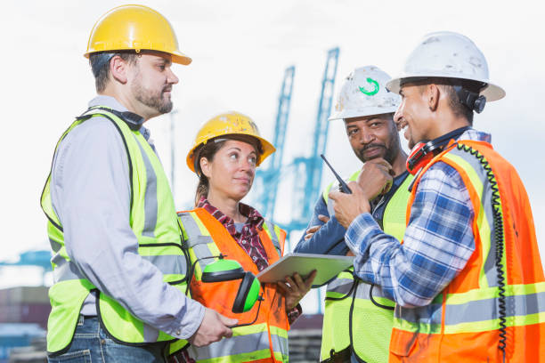 istock Multi-ethnic workers at shipping port, woman in charge 898438704