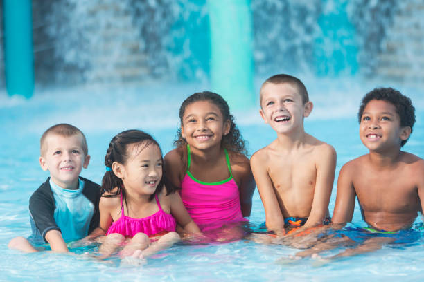 istock Group of multi-ethnic children in pool at water park 898439114