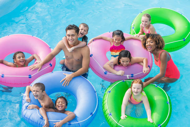 istock Multi-ethnic children, fun on lazy river at water park 898439186