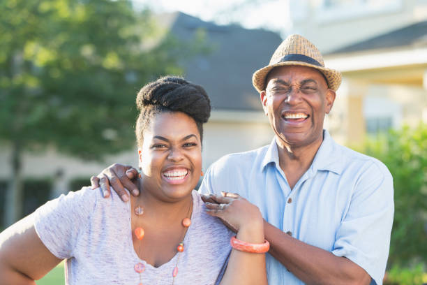 istock Senior man in front yard with adult daughter 898439426