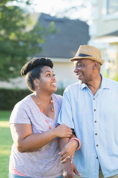 istock Senior man in front yard with adult daughter 898439442