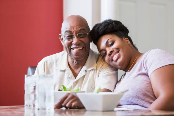 istock Senior man and adult daughter eating together 898439708