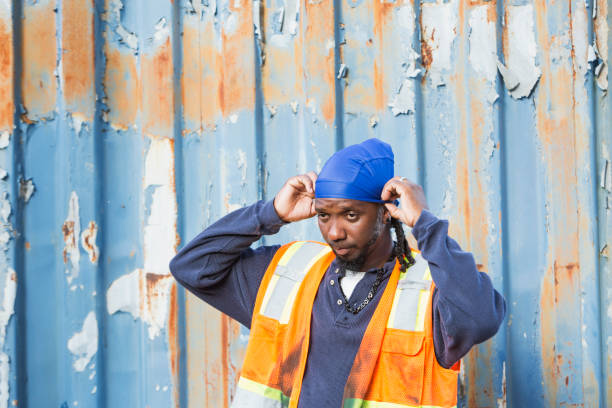 Worker standing in front of old semi-truck trailer