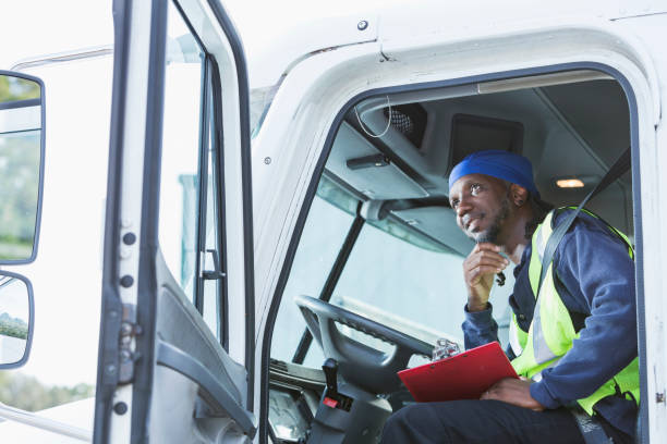 istock Mature black man driving semi-truck 898440490