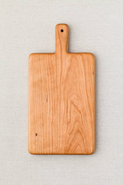 istock Cherry wood cutting board on linen, handmade wood cutting board 898441948