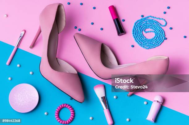 Pink Suede High Heels On Pink And Blue Split Background With Accessories Stock Photo - Download Image Now