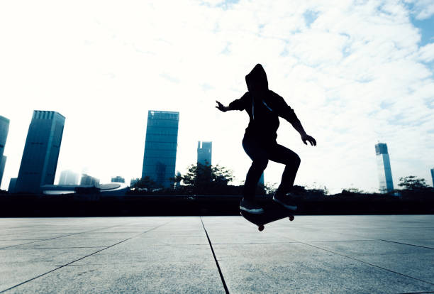 istock Skateboarder doing a trick named ollie on city with skateboard 898443498