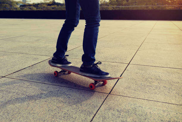 istock female skateboarder riding with skateboard on city 898445738