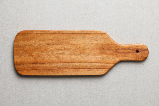 istock Handmade wood cutting board on the linen 898450420