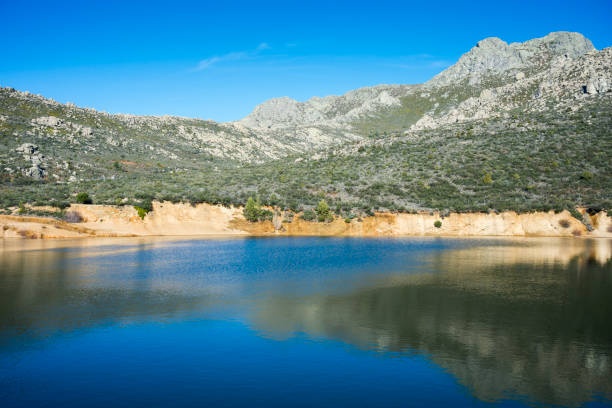 Views of La Maliciosa Reservoir, in Guadarrama Mountains (Madrid, Spain), with La Maliciosa peak in the background.