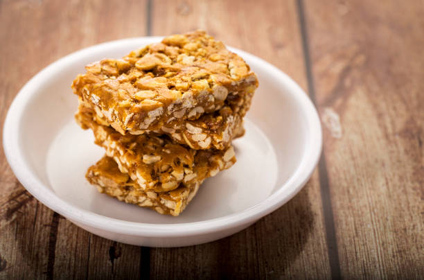 chikki arachidi fragili o a base di arachidi con jaggery - roasted sesame seeds foto e immagini stock