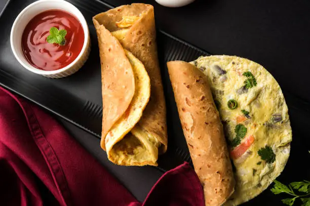 omelette / omlet / omlete chapati roll or Indian bread or roti rolled with omlet. Popular, quick and healthy recipe for kid's tiffin or lunch box