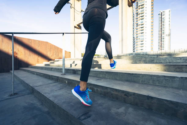 istock woman running up stairs,low section 898453734