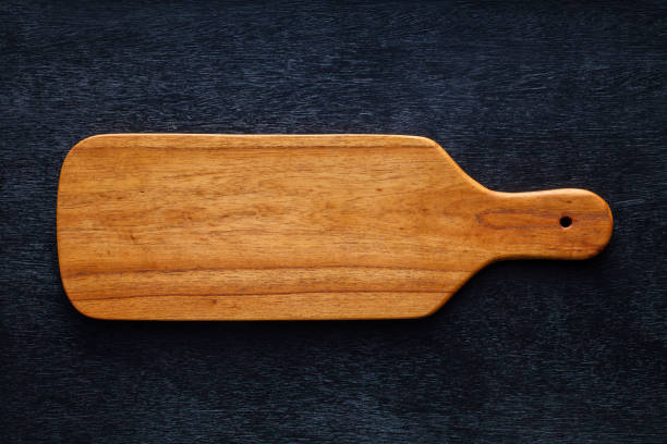 istock Handmade wood cutting board on black wooden board 898454216