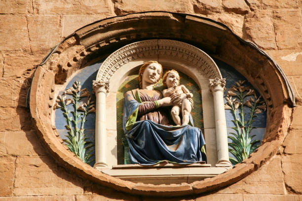 medallion with the virgin mary and child by Luca della Robbia on the facade of Orsanmichele church in Florence, Italy