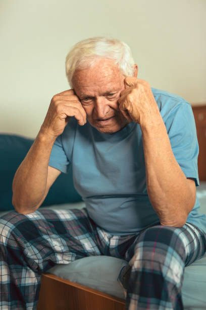 istock Senior Man Sitting On Bed At Home Suffering From Depression 898457428